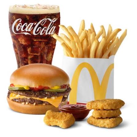 golden crispy french fries in a red fry holder on a dark concrete table
